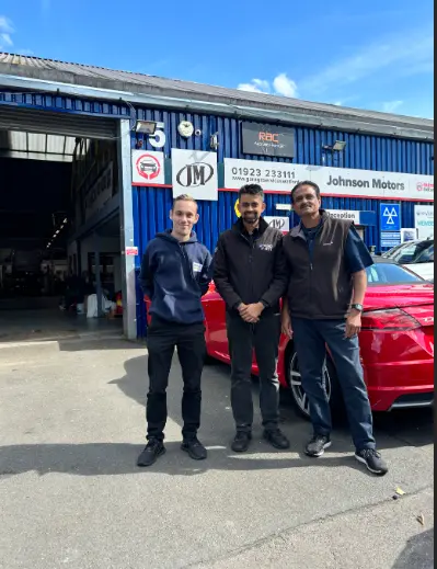 BookMyGarage employee posing outside Johnson Motors in Watford with garage employees